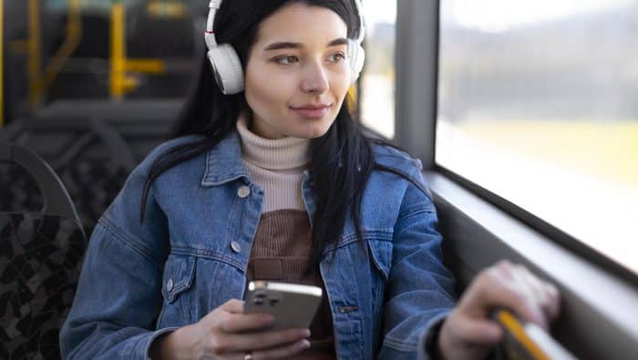 medium shot woman wearing headphones