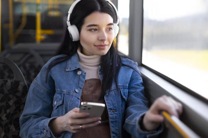 medium shot woman wearing headphones